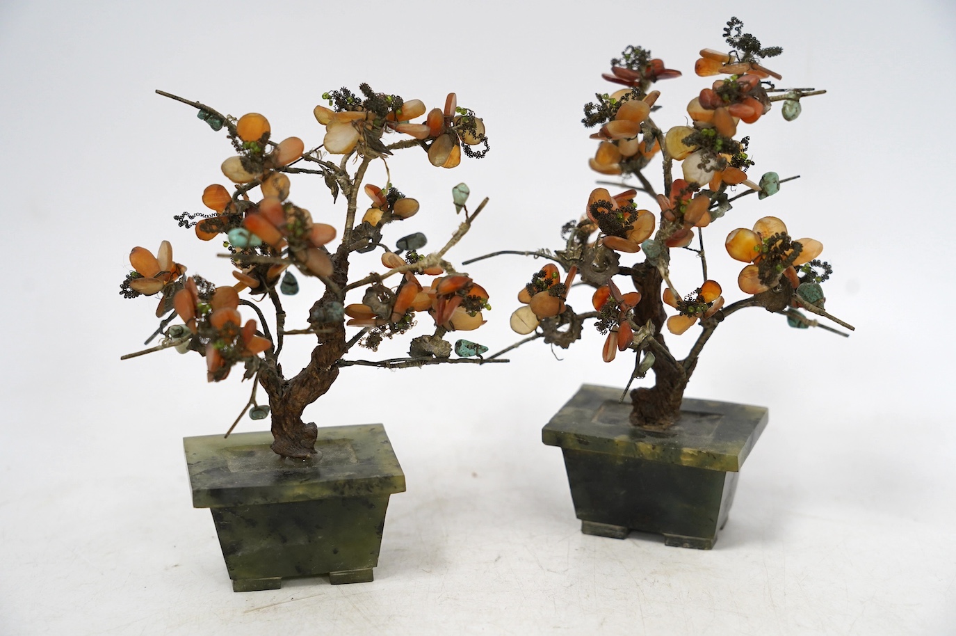 Two pairs of Chinese jade and hardstone mounted models of trees, tallest 16cm. Condition - fair, some losses